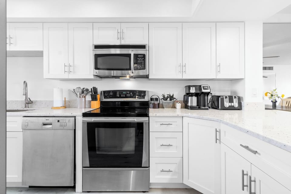 Sleek and modern kitchen with stainless steel appliances, granite countertops, and plenty of storage.