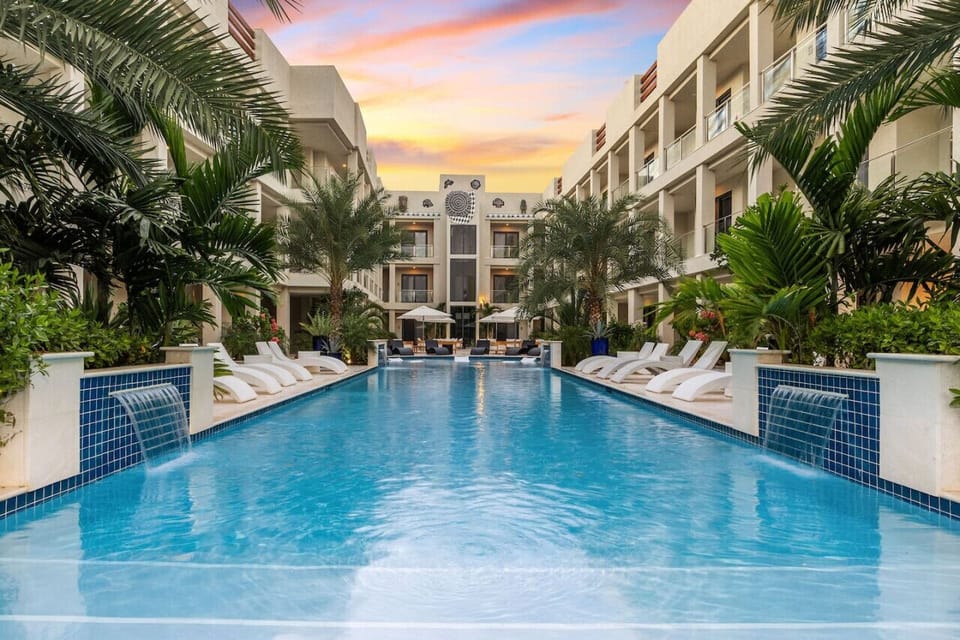 Relax by the pool, surrounded by lush greenery and quiet comfort—perfect for slow mornings and sunset dips.