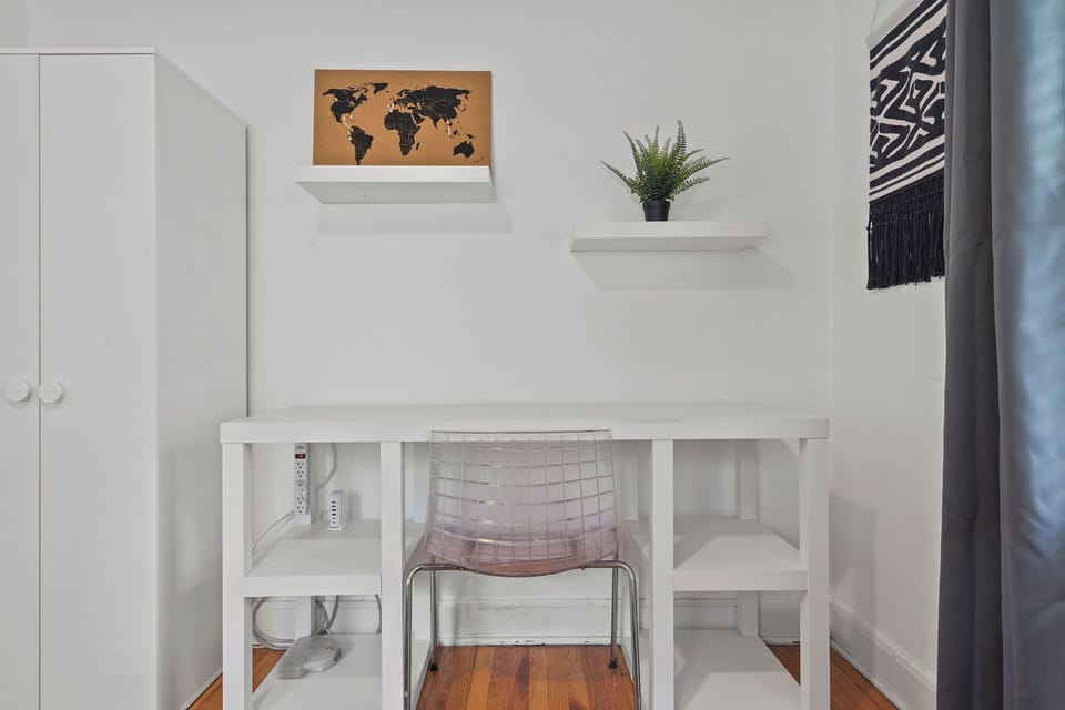 Convenient workspace with floating shelves and natural light—perfect for remote work, studying, or planning your Kansas City adventures.