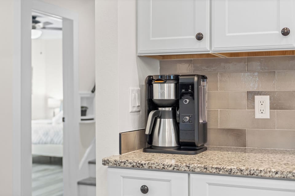 Start your mornings right with the convenient Ninja coffee maker in the kitchen.
