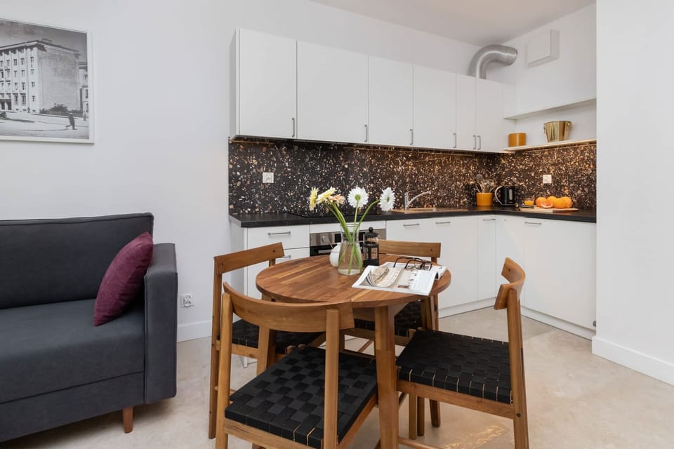 Another perspective of the dining and kitchen area, showcasing its practical design and comfortable atmosphere for shared meals.








