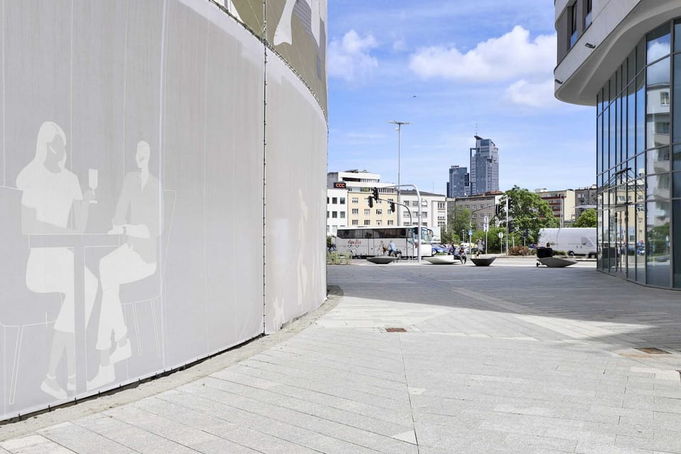 Another angle of the courtyard, featuring paved pathways and ample open space for walking or relaxing.

