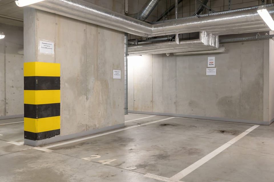 A secure underground parking area with well-marked spaces and bright lighting for convenience and safety.


