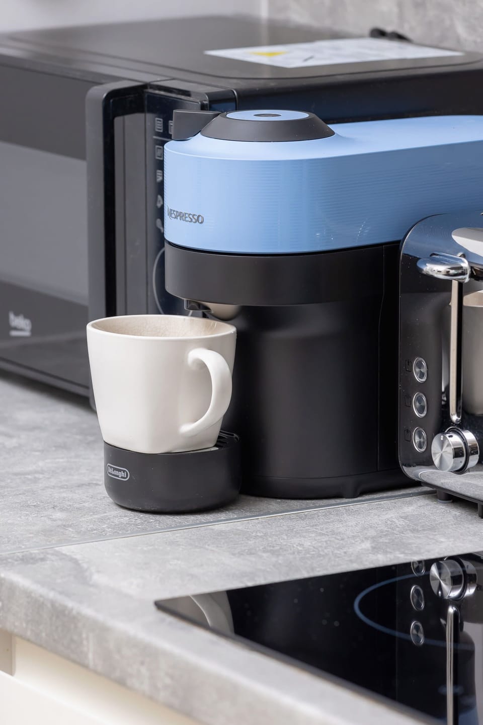 A close-up of a sleek coffee machine, perfect for enjoying a fresh brew during your stay.

