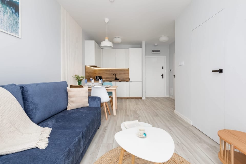 A wide-angle view of the living room, highlighting its bright and airy feel, complemented by minimalist decor.

