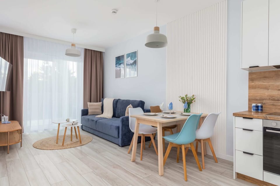 A full view of the apartment’s layout, blending modern kitchen design with comfortable living and dining areas.

