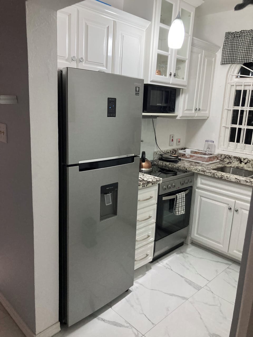 Very clean kitchen with microwave blender coffeemaker waffle maker 