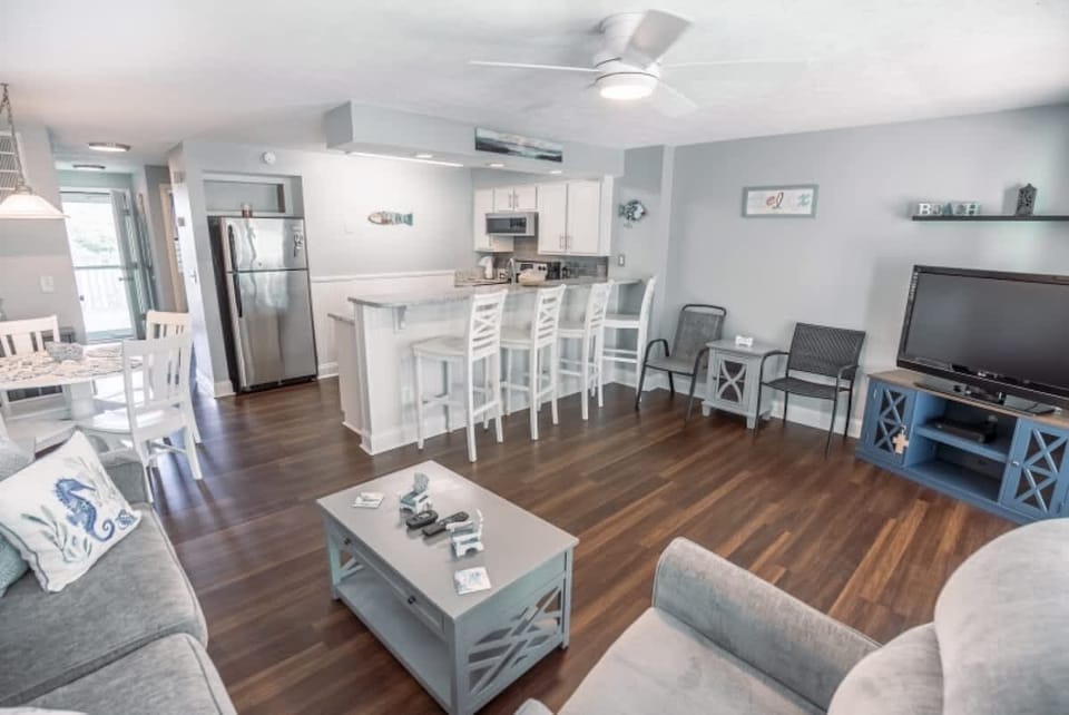 The open-concept layout connects the kitchen, dining area, and living room, creating a warm and inviting atmosphere.