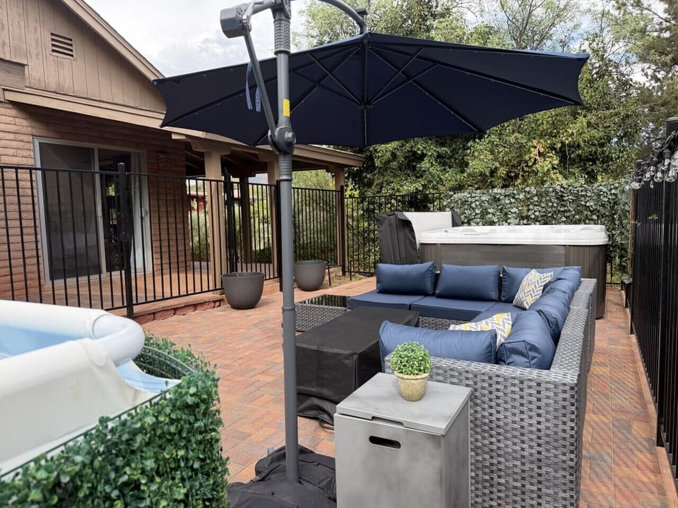 Fenced lounging patio with hot tub and pool