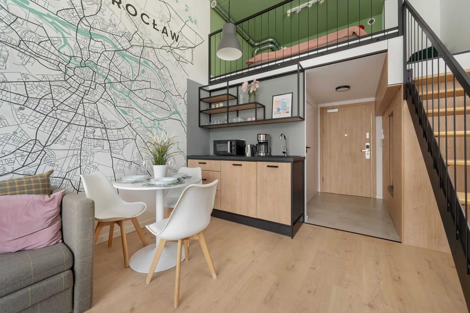 Another angle of the living and dining space, showcasing the bright and airy layout with natural light.

