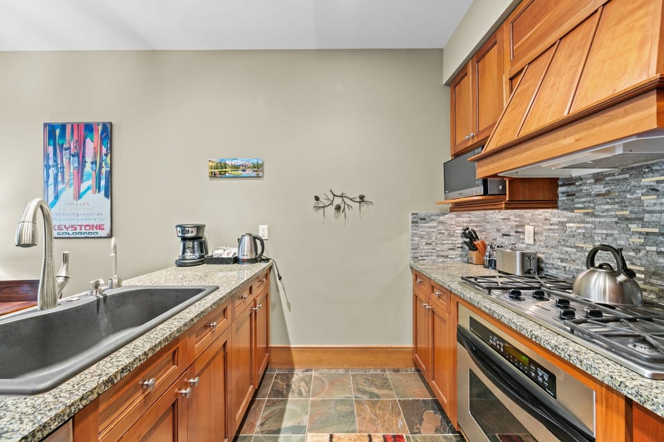 Your gourmet kitchen features warm wood cabinets, granite counters, and top appliances for memorable home-cooked meals.