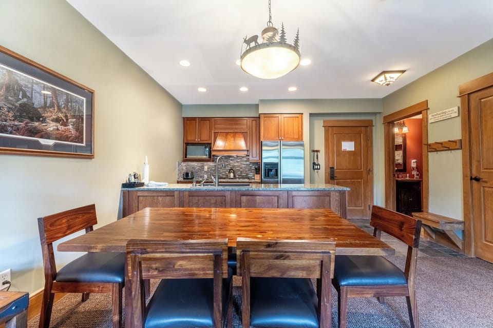 Gather around your rustic dining table with mountain views while the full kitchen invites culinary adventures.