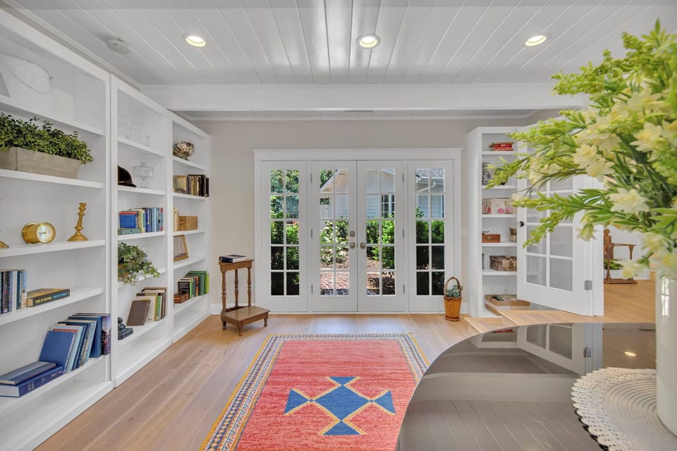 Main house: off of the entryway is  this spacious room with piano, endless collection of books, and direct access to the back courtyard.