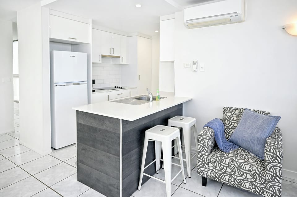 A comfy chair to read in to, with the galley kitchen behind