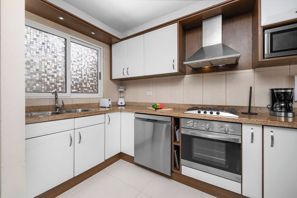 The spacious countertops offer ample prep space, while the open layout ensures you're always part of the conversation. Perfect for travelers who enjoy the convenience and flexibility of cooking at home during their stay.