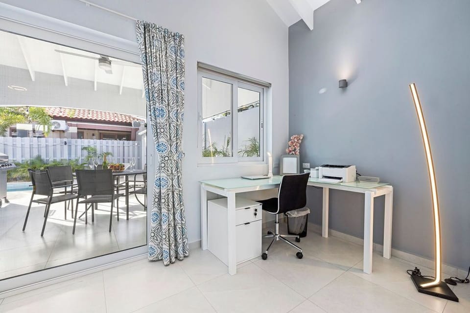 This bathroom comes with complete amenities, a toilet, and a shower with a glass partition.