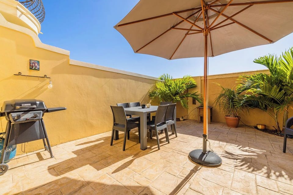 Bright and spacious outdoor space with seating and BBQ area.