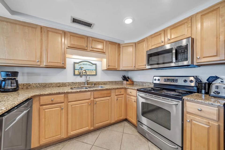 Kitchen with stove, oven, refrigerator, freezer, dishwasher, and microwave