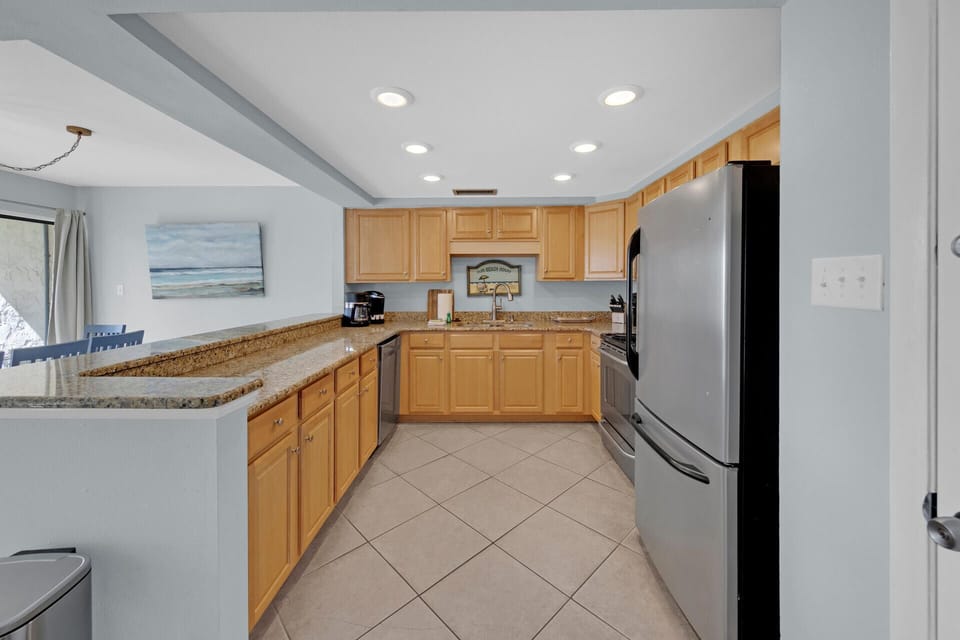 Kitchen adjoins dining room and balcony