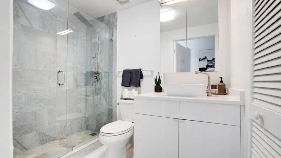 Spacious bathroom complete with sink, toilet, and shower
