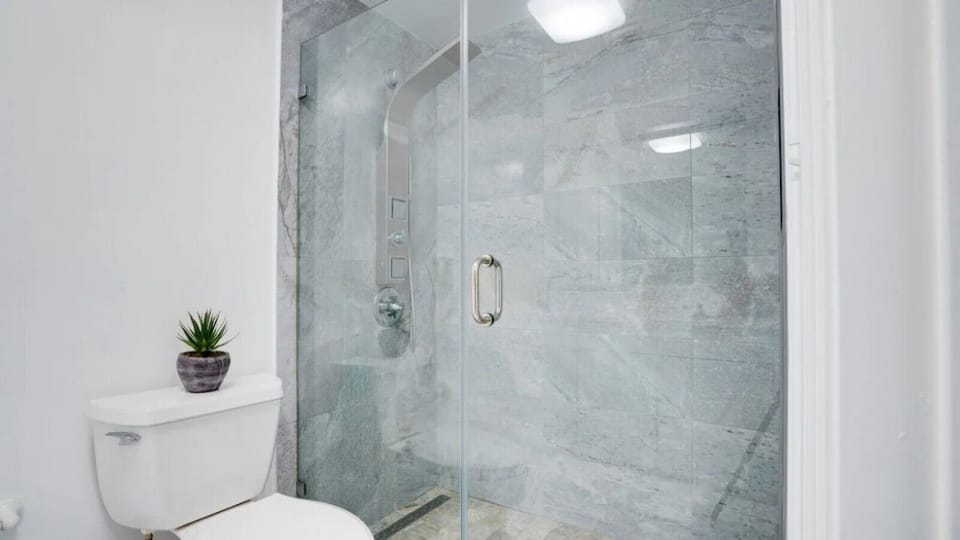 Spacious bathroom complete with sink, toilet, and shower