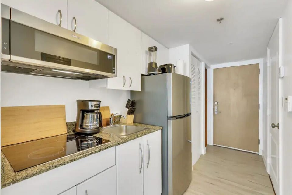 Kitchen area with appliances and cookware