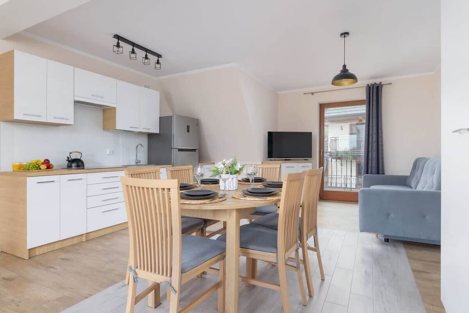 An open-concept dining area connected to a well-equipped kitchenette, perfect for enjoying meals and socializing.

