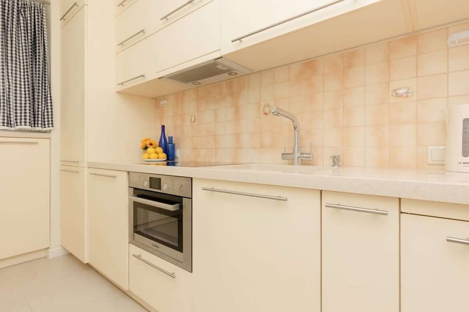 Kitchen with oven and electric kettle.
