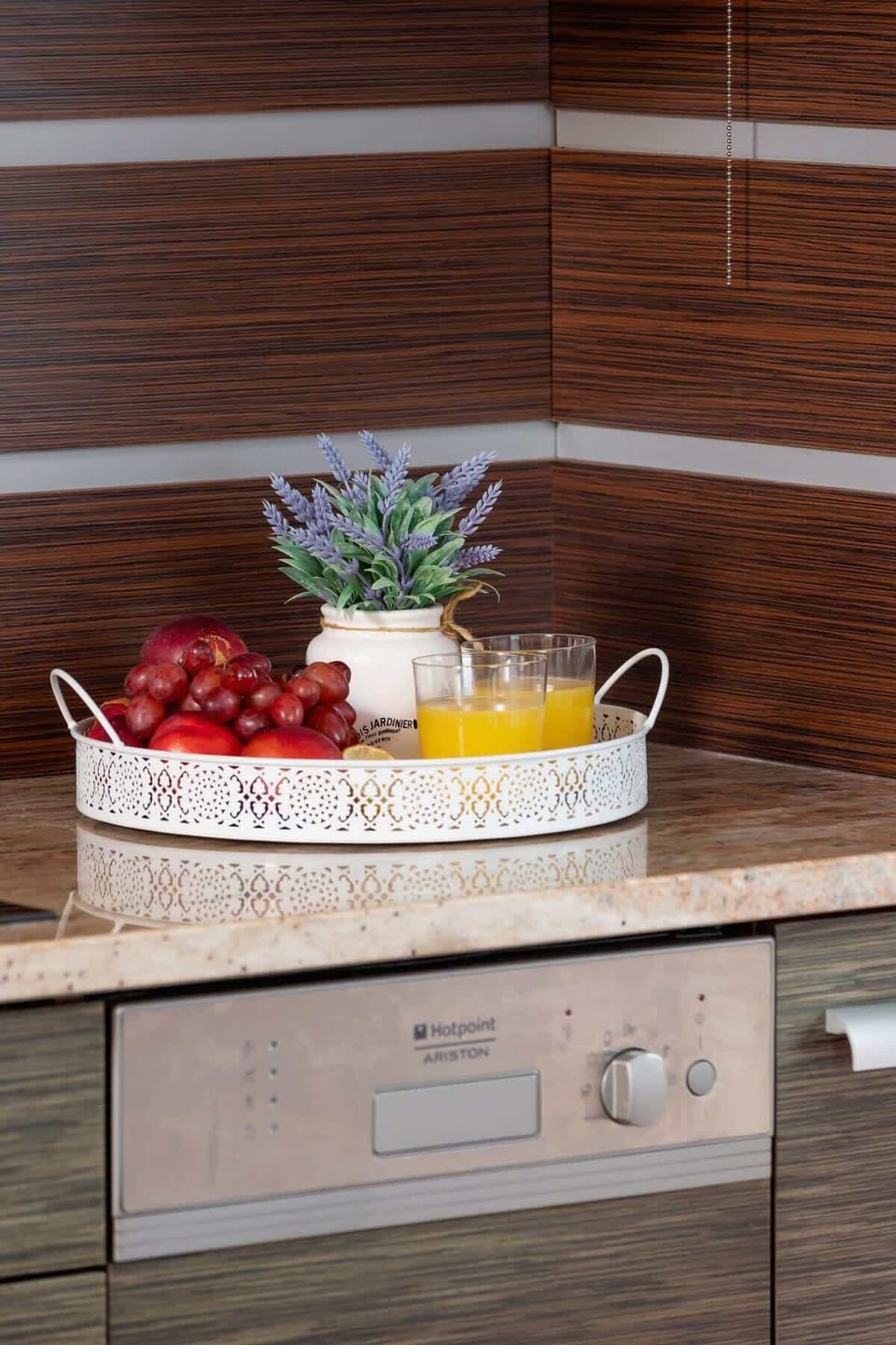 A stylish kitchen corner with a decorative fruit basket adding a touch of freshness.

