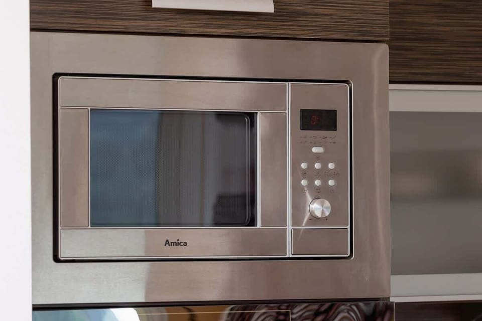 A modern microwave oven, ensuring convenience during the stay.

