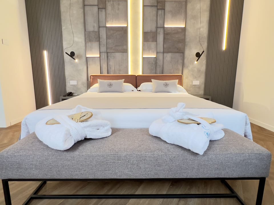 Deluxe Quadruple Room, Jetted Tub | In-room safe, iron/ironing board, free WiFi, bed sheets