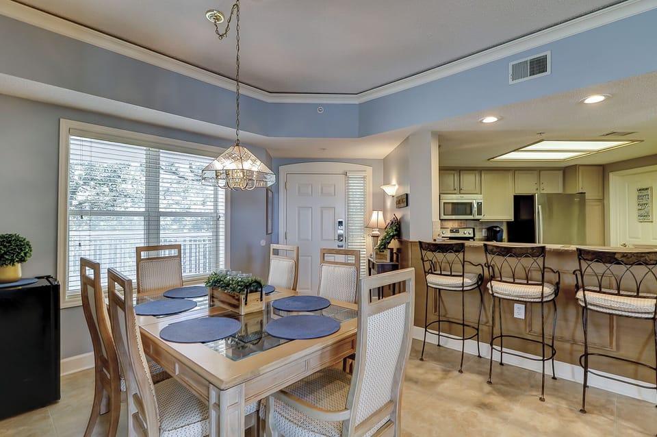 Dining and kitchen with bar seating