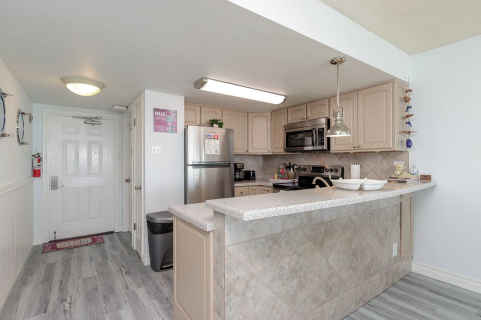 Your spacious kitchen features granite counters, stainless appliances, and a breakfast bar perfect for morning coffee or casual dining.