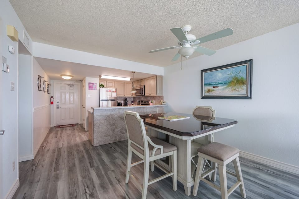 Step into your bright, modern kitchen and dining space where coastal charm meets convenience for your perfect getaway meals.