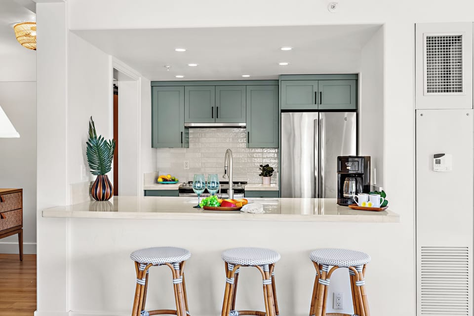 Thoughtfully designed for relaxed resort living, this bright and modern kitchen features sleek quartz countertops, stainless steel appliances, and a clean coastal aesthetic—perfect for preparing everything from fresh island breakfasts to sunset refreshment