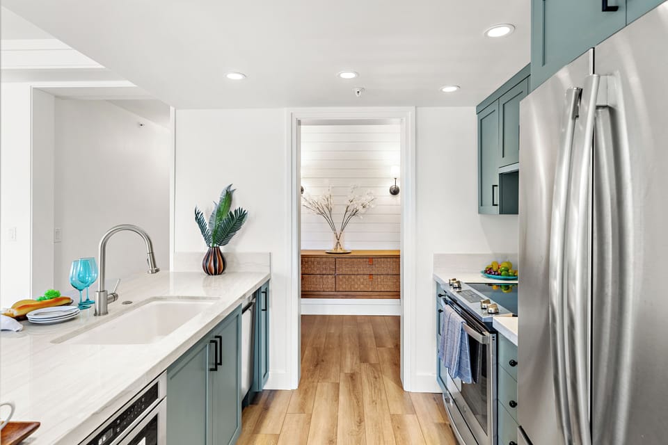 Your gourmet kitchen awaits with cabinetry, counters, and stainless-steel appliances. Perfect for preparing memorable meals together.