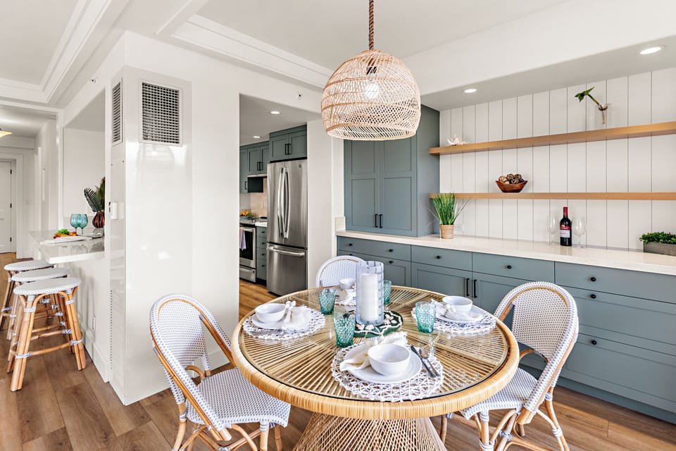 An inviting dining space where island elegance meets breathtaking ocean views. Gather around the beautifully set table, surrounded by warm textures, coastal-inspired décor, and soft ambient lighting.