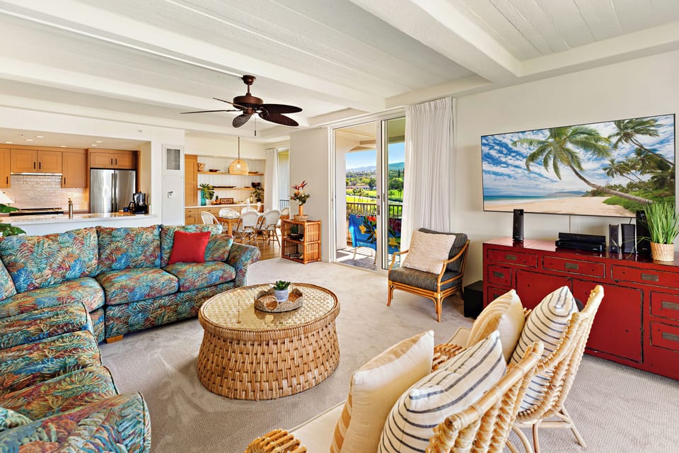 Bright and welcoming, the spacious living room offers comfortable seating, island-inspired décor, and seamless access to the private lanai.