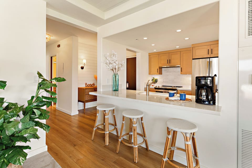 Designed for both functionality and entertaining, the open-concept kitchen seamlessly connects to the living and dining areas for effortless Maui living.