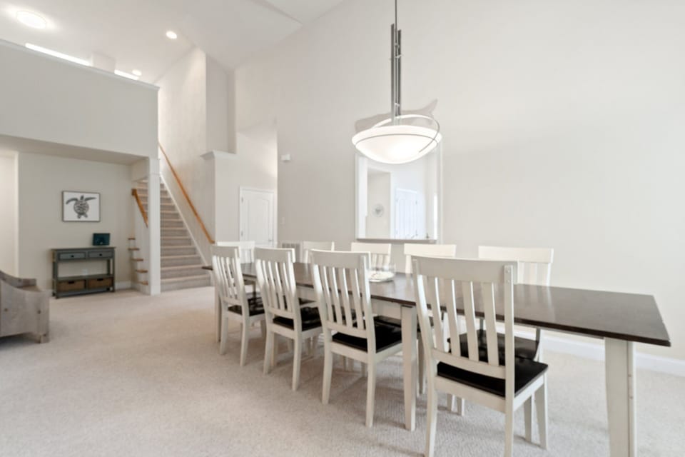 Dining area with stairs to two bedrooms and loft; two bedrooms down the hall.
