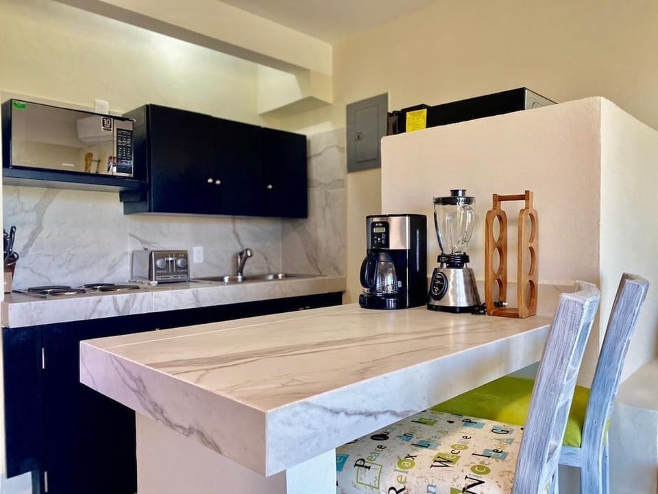 Full-size fridge, microwave, stovetop, coffee/tea maker