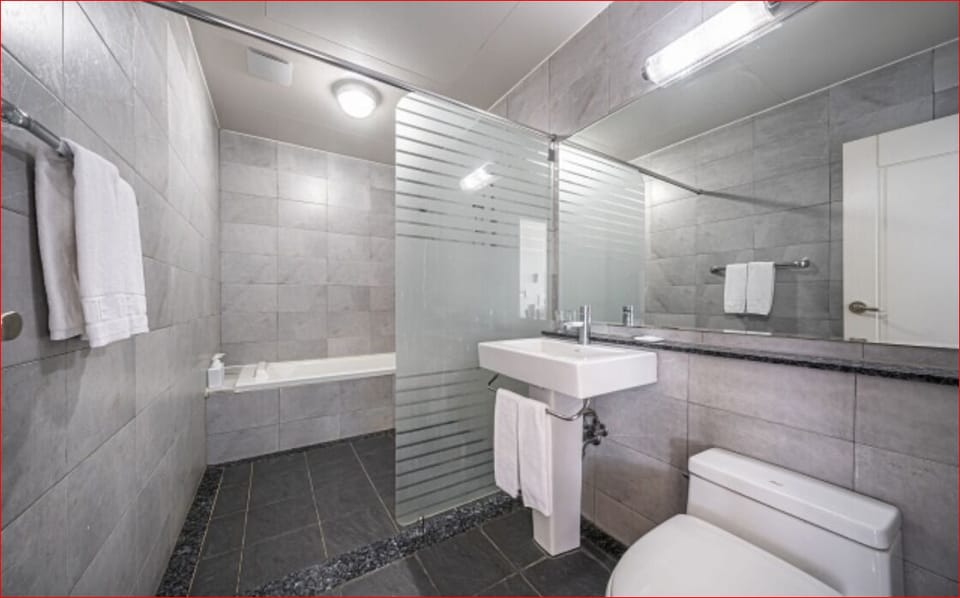 Ocean Suite C (with Bathtub) | Bathroom | Hair dryer, slippers, towels