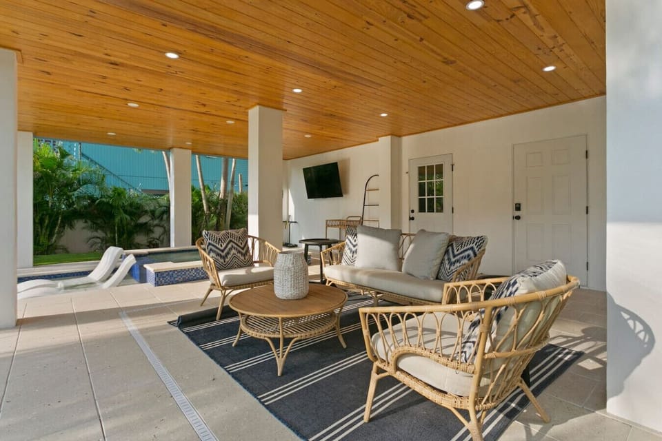 pool sitting area w/ tv and grill