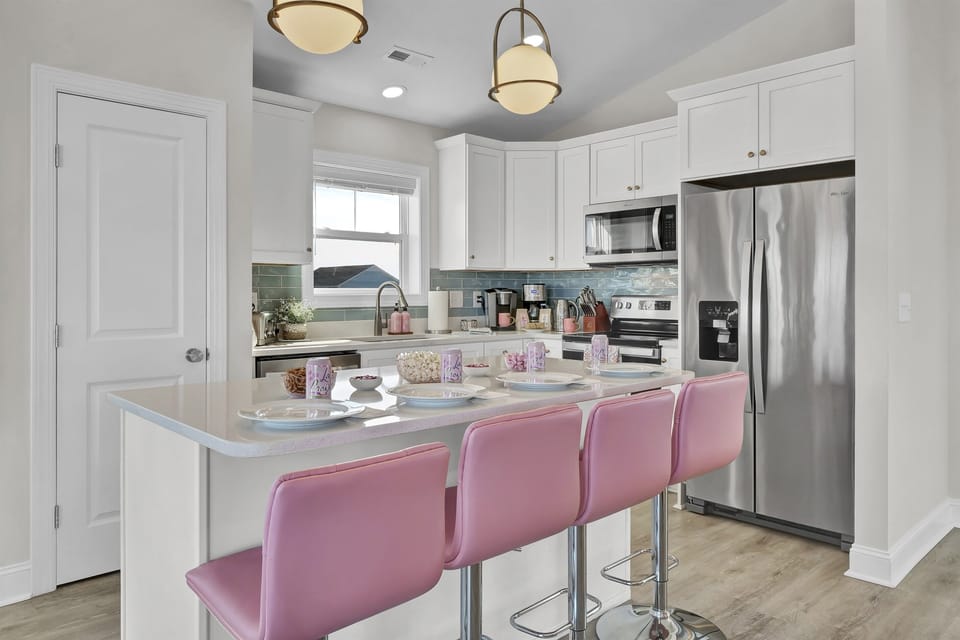 Cook, dine, and connect in the fully stocked kitchen, complete with modern appliances and bar seating for four.