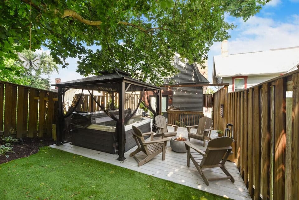 Relaxing outdoor lounge with gazebo, fire pit, and shaded seating