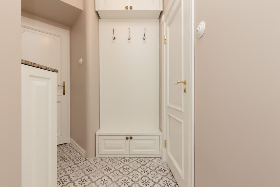 A stylish built-in storage, coat hooks, and a bench, combining practicality with elegance.

