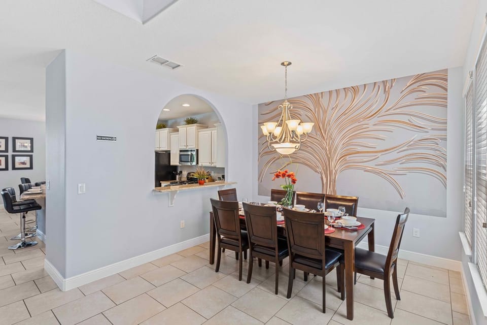 Elegant dining area of the home in Davenport Florida - 8 Persons dining - Chic dining area featuring a stylish table and contemporary seating - Harmonious color scheme for a cohesive and stylish look - Beautiful wall designed