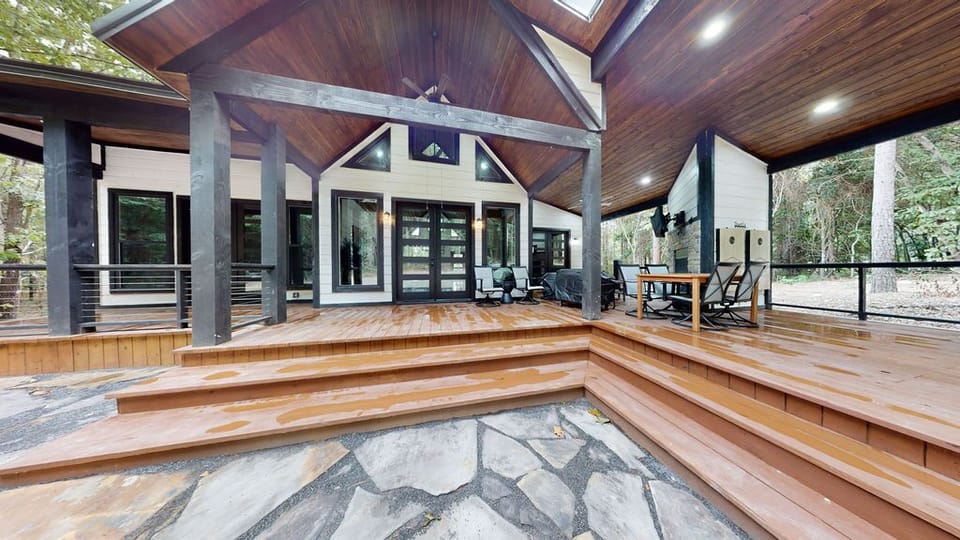 Relax on the covered back deck surrounded by the quiet beauty of the forest.