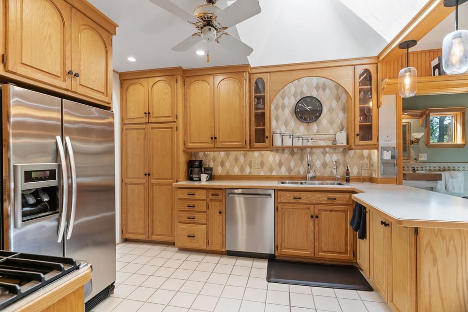 Prepare delicious meals in your spacious kitchen featuring warm wood cabinets, modern appliances, and plenty of counter space for cooking.