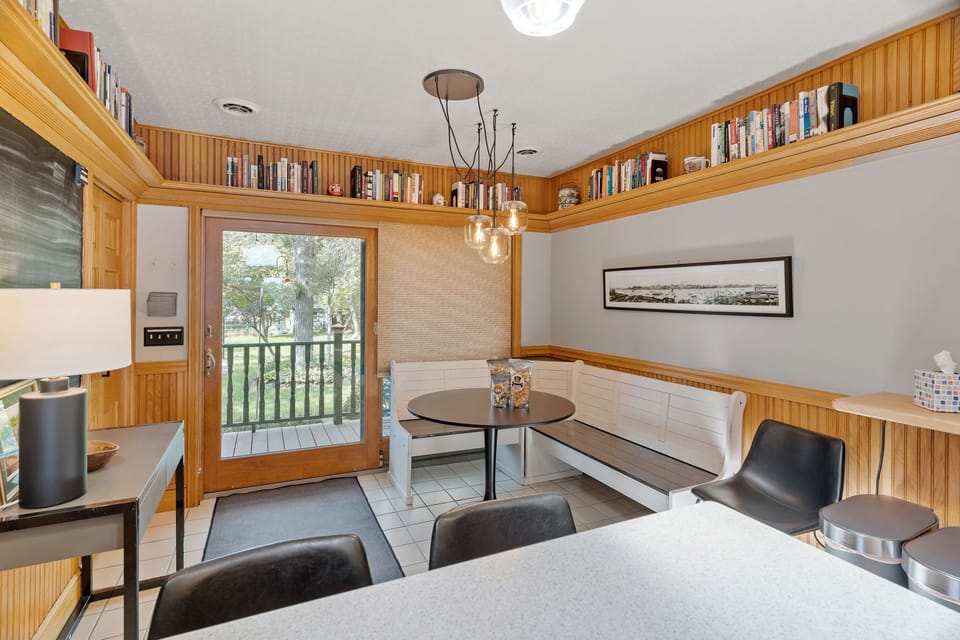 Cozy kitchen nook where you'll love sharing meals surrounded by books and warm wood details.